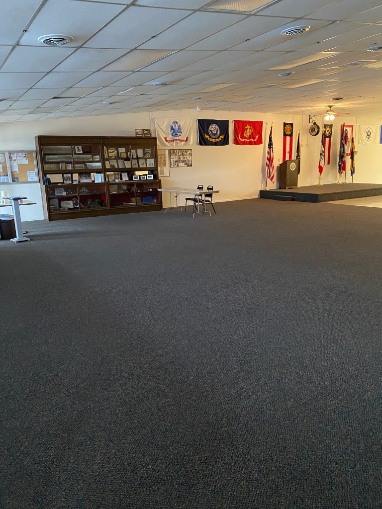 Large facility with lots of room. Carpeted area with tile dance floor in front of a carpeted stage